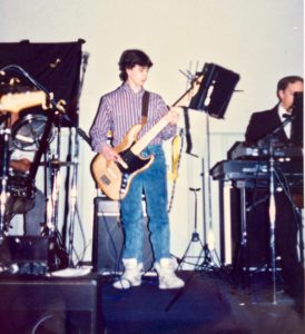 Damian Coccio as a teenager playing bass guitar