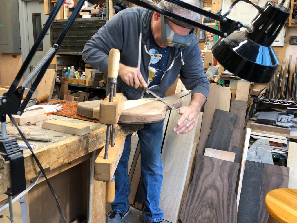 Vinny Fodera carving the bass body